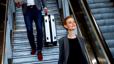 Business-people-walking-down-stairs