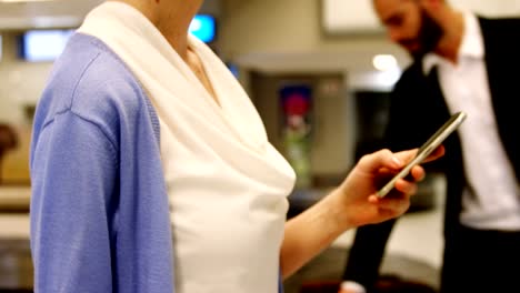 Female-passenger-using-mobile-phone