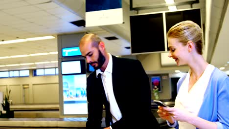 Businessman-taking-his-luggage-off-the-baggage-carousel