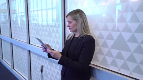 Business-woman-using-digital-tablet-at-airport