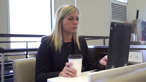 Business-woman-using-digital-tablet-at-airport