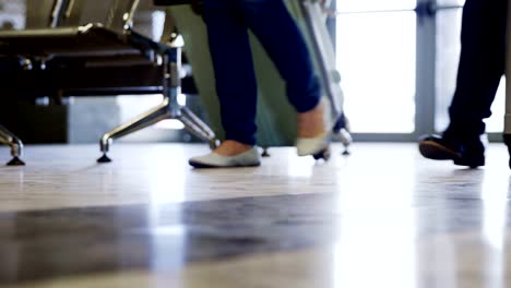 Passengers-walking-with-their-luggage-at-airport