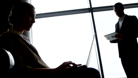 Businesswoman-using-laptop-at-airport