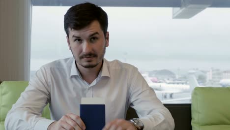 Handsome-man-waits-for-boarding-in-the-lounge-hall