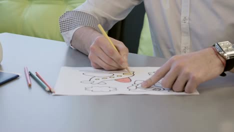 Businessman-paints-coloring-book-in-airport-during-waiting-boarding-on-plane