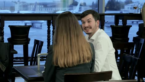 Handsome-people-have-the-conversation-in-the-bar-of-the-airport