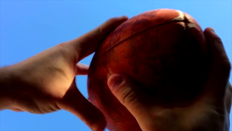 Super-slow-motion-of-hands-catching-football