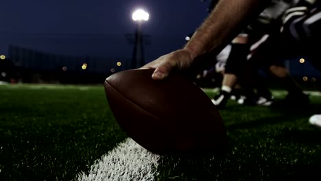 Close-up-of-a-hand-on-a-football-about-to-hike-it