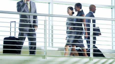 Caucasian-American-businessman-using-mobile-technology-in-airport