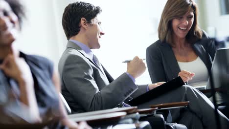 Caucasian-businesswoman-meeting-with-colleague-in-airport-lounge