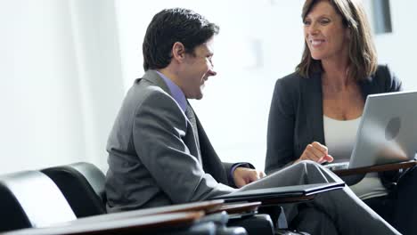 Caucasian-female-financial-manager-meeting-colleague-in-airport