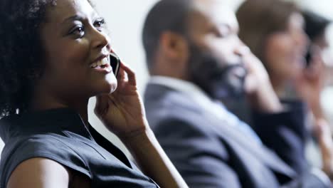 Ethnic-businesswoman-using-smart-phone-in-airport-lounge