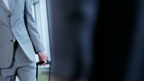 Caucasian-female-business-travellers-talking-in-airport-lounge