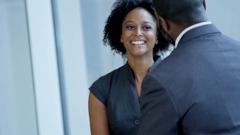 Successful-ethnic-business-passengers-talking-in-airport-lounge