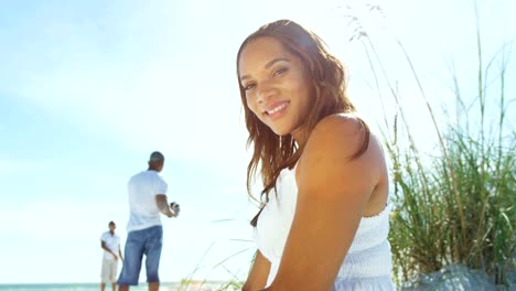 Portrait-of-African-American-female-sitting-on-beach