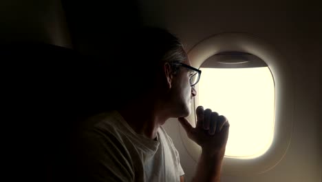 man-looking-out-of-airplane-window