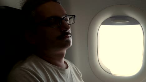 Man-sleeping-inthe-plane