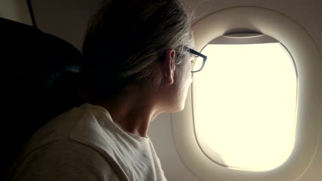 man-looking-out-of-airplane-window