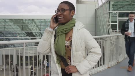 Businesswoman-walking-and-talking-at-airport