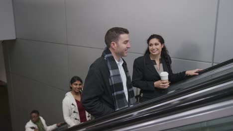 Businesspeople-on-escalator-talking