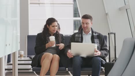 Businessman-and-businesswoman-meeting-at-airport