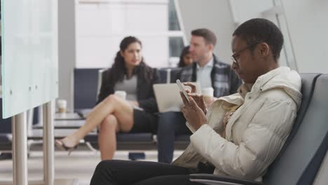 Woman-using-cell-phone-at-airport