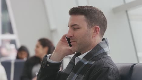 Business-man-talking-on-cell-phone-at-airport