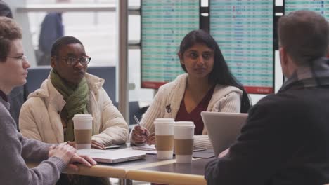 Group-of-businesspeople-meeting-at-airport