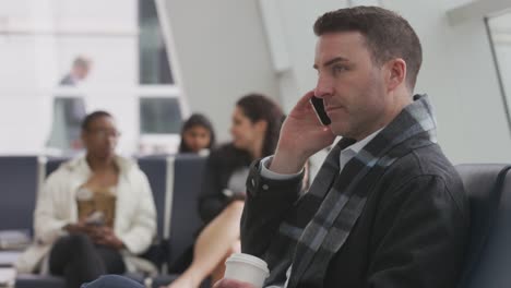 Business-man-talking-on-cell-phone-at-airport