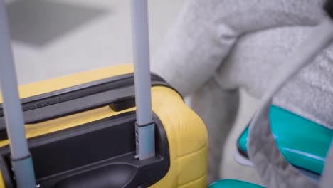 Close-up-shot-of-a-charming-brunette-woman-quietly-sitting-with-her-baggage