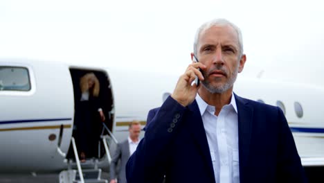 Businessman-talking-on-mobile-phone-at-terminal-4k