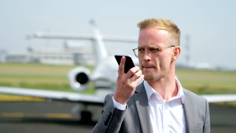 Businessman-talking-on-mobile-phone-at-terminal-4k