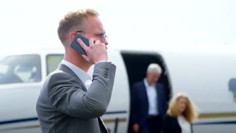 Businessman-talking-on-mobile-phone-at-terminal-4k