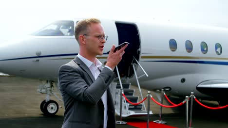 Businessman-talking-on-mobile-phone-at-terminal-4k