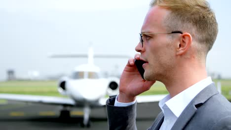 Businessman-talking-on-mobile-phone-at-terminal-4k