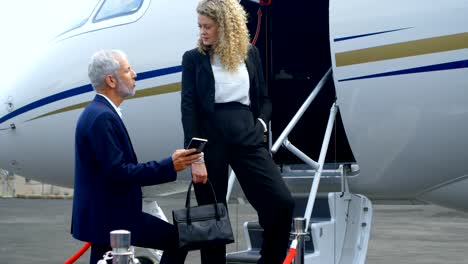 Business-people-interacting-with-each-other-at-the-entrance-of-private-jet-4k