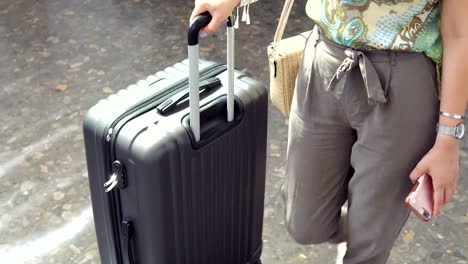 Young-beautiful-woman-with-travel-bag-from-the-terminal-at-the-airport-or-train-station