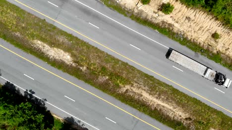 Drone-shot-high-angle-Aerial-view-of-highway-traffic-at-the-countryside,-The-car-truck-and-motorcycle-transport