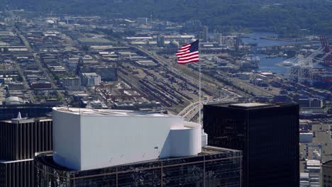 American-Flag-Waving-on-Building-Top-Slow-Motion-Aerial