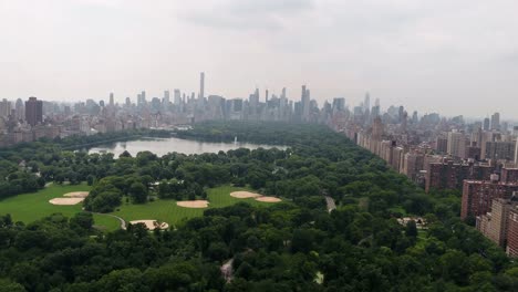 Central-Park-aerial-pulling-back-over-meadow-Manhattan-New-York-City