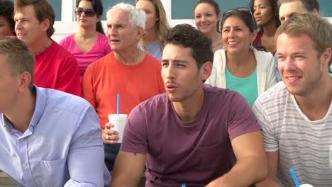 Group-Of-Young-Men-Cheering-At-Outdoor-Sports-Event