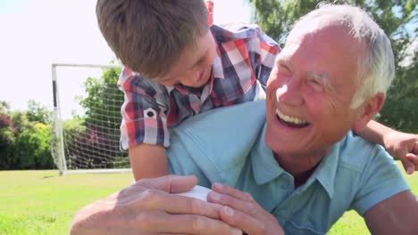 Slow-Motion-Shot-Of-Grandfather-And-Grandson-With-Football