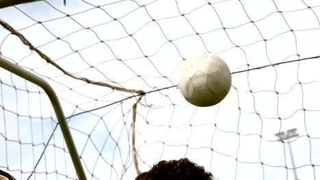 Goalkeeper-in-red-letting-in-goal-during-a-game