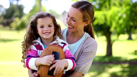 Mother-and-daughter-holding-a-ball