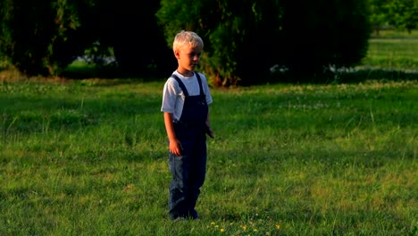 Elementary-alter-Junge-treten-Kugel-im-Feld