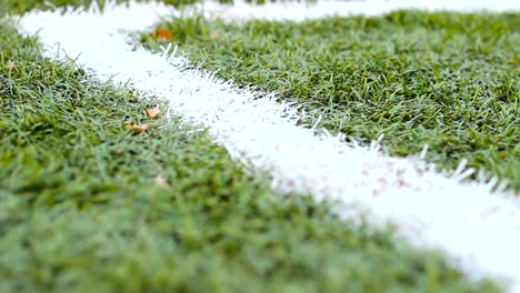 Close-up-of-the-out-of-bounds-line-on-a-turf-football-field