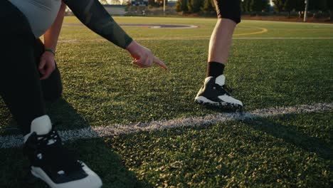 Close-up-of-a-football-player-kicking-the-ball-toward-the-goal-posts