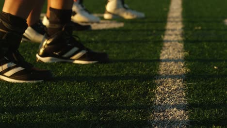 Close-up-of-a-football-player-lining-up-at-the-line-of-scrimmage