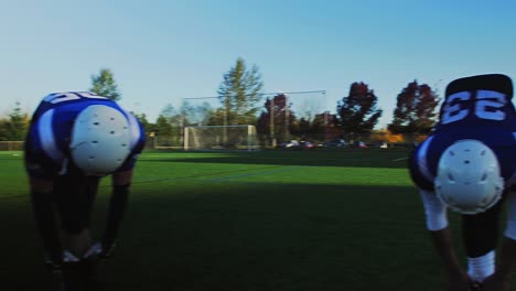 View-from-inside-the-circle-of-football-players-stretching-before-a-game