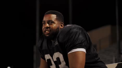 A-football-player-cheering-on-his-team-from-the-sidelines